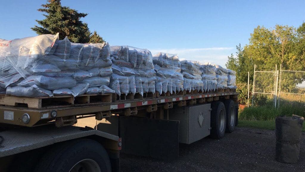 Close view of wrapped sandbag pallets on a flatbed